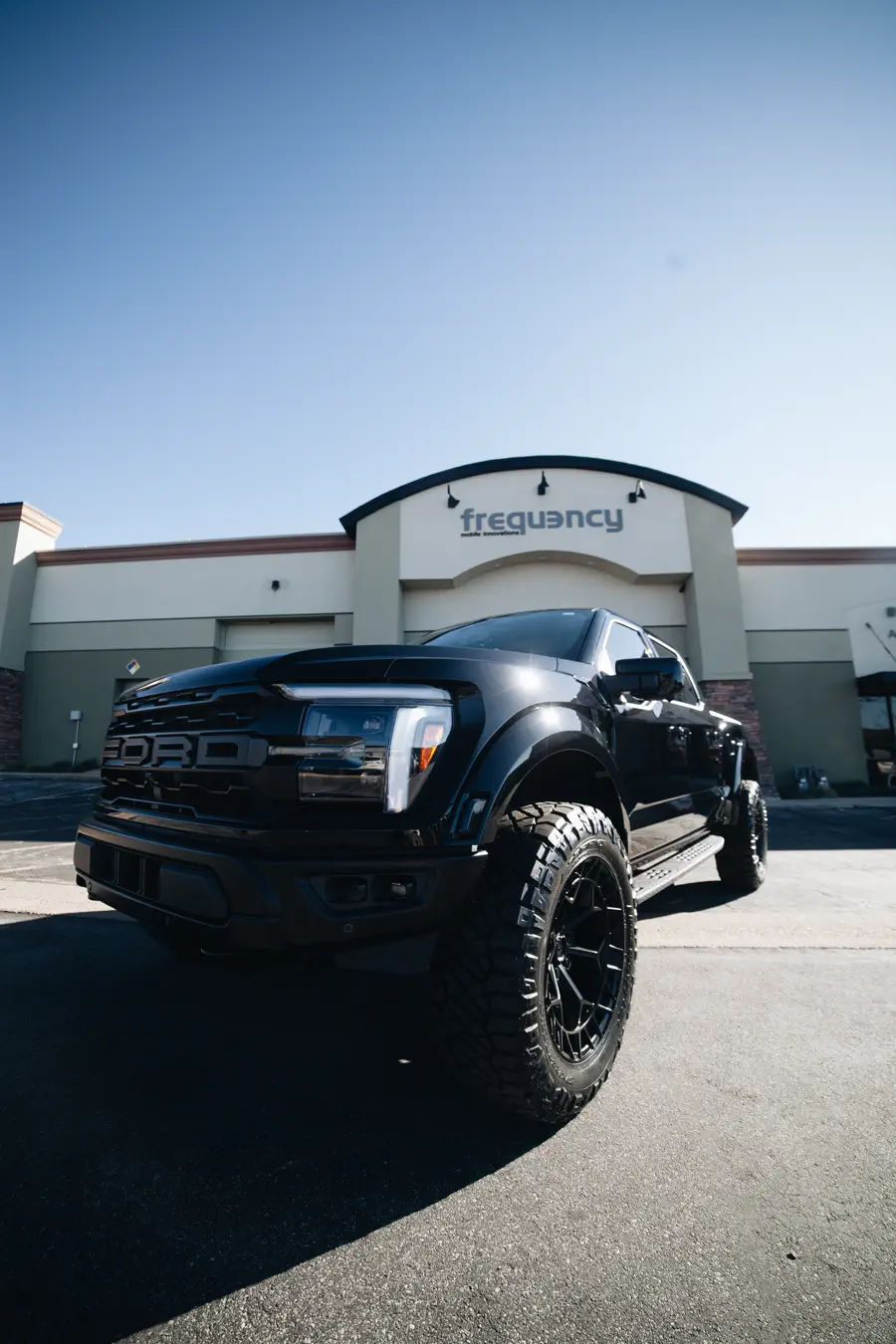 Blacked-out Ford Raptor with powder coated wheels